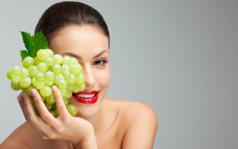 Woman Holding Grapes — Green