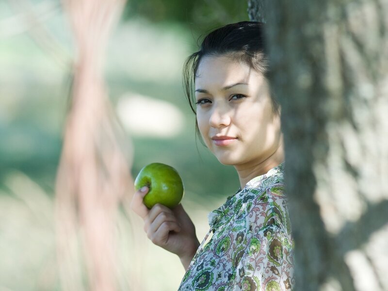 Woman Holding Green Apple — Serene