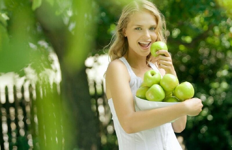 Woman Holding Green Apples — Happy