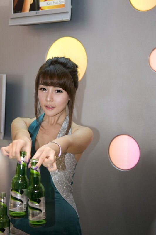 Woman holding green bottles