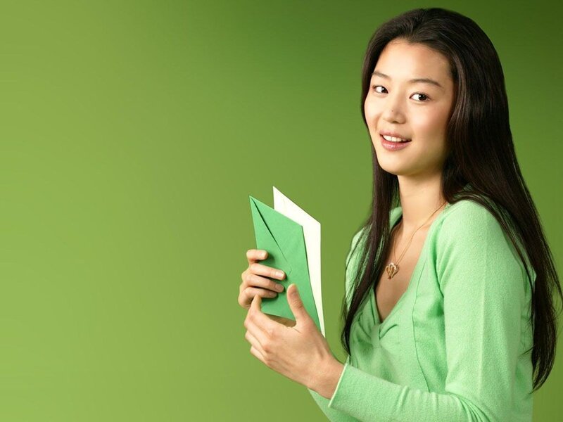 woman holding green envelope
