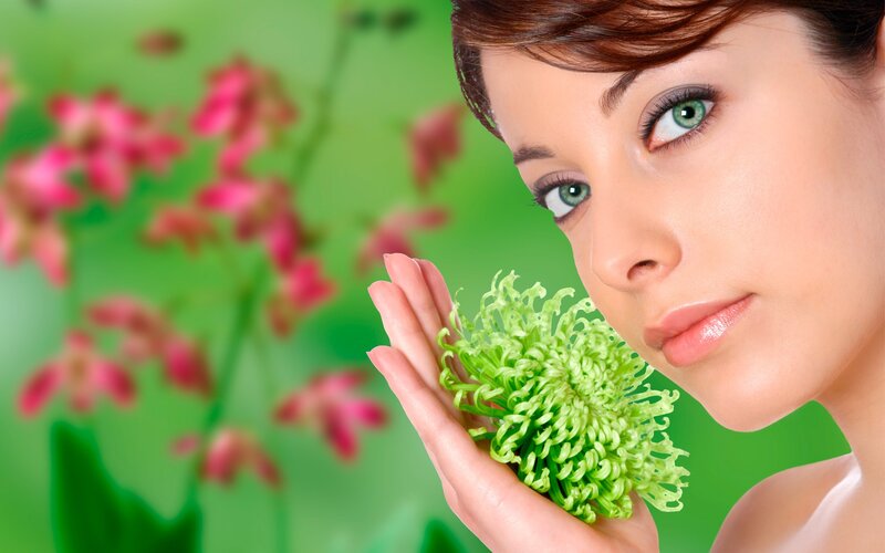 woman holding green flower