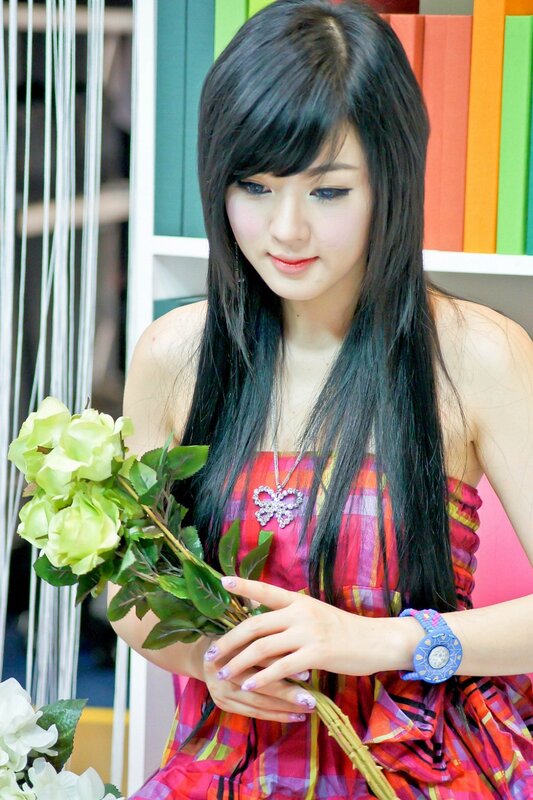 woman holding green flowers