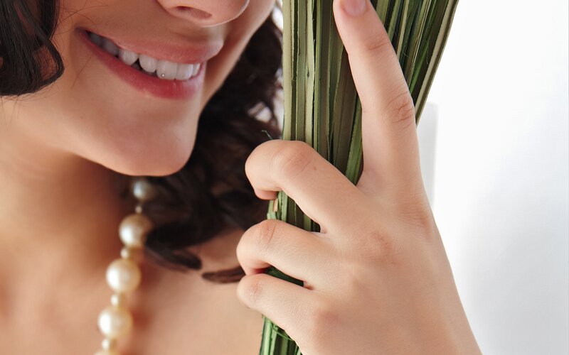 woman holding green leaves