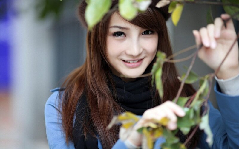 woman holding green leaves