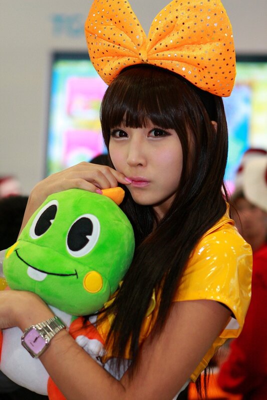 woman holding green plush toy