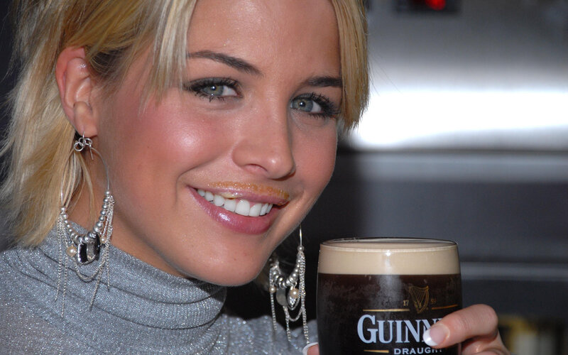 woman holding guinness beer