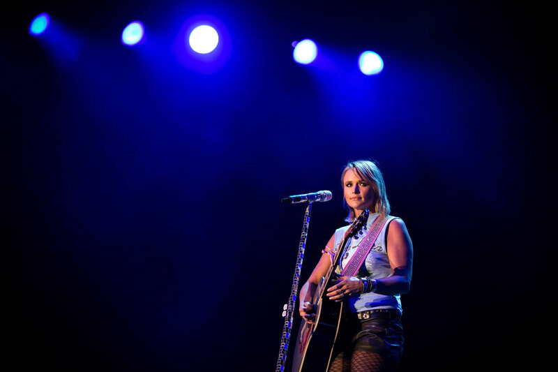 Woman Holding Guitar — Blue, Dramatic