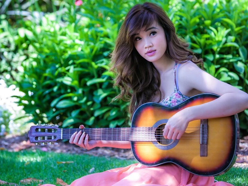Woman Holding Guitar — Green, Serene