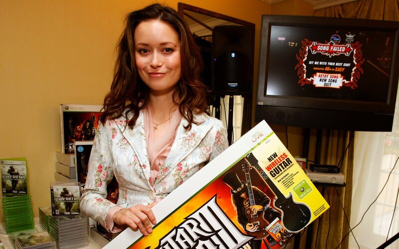 Woman holding Guitar Hero II box