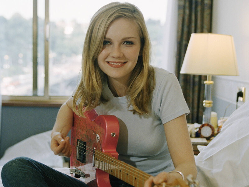Woman Holding Guitar — Red, Relaxed