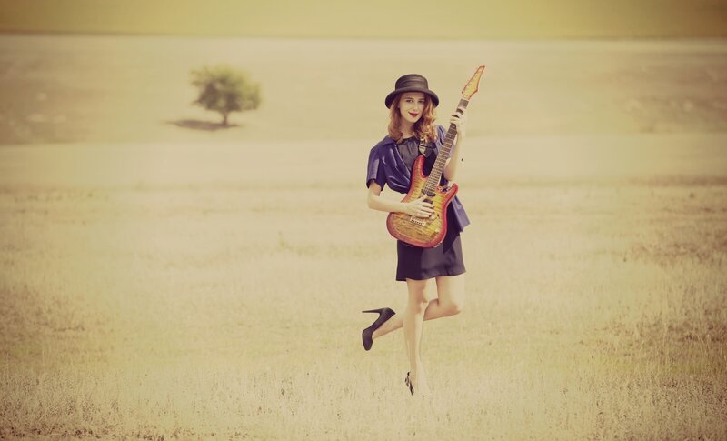 Woman Holding Guitar — Yellow, Serene
