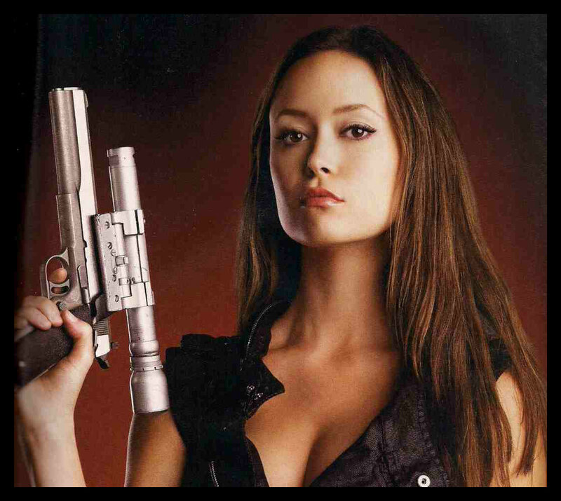 Woman Holding Gun — Brown, Serious, Photograph, Black Top