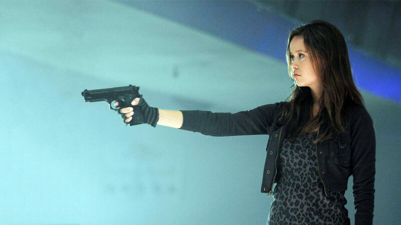 woman holding gun in action scene