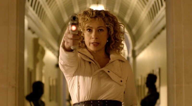 Woman holding gun in hallway