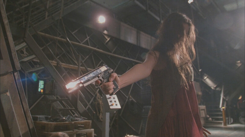 woman holding gun in industrial setting