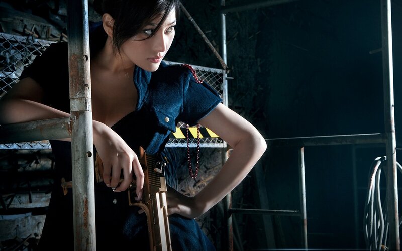 woman holding gun in warehouse