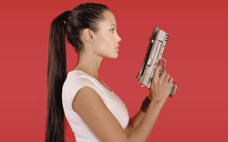 Woman Holding Gun — Red, Dramatic, Photograph, Ponytail, White Shirt