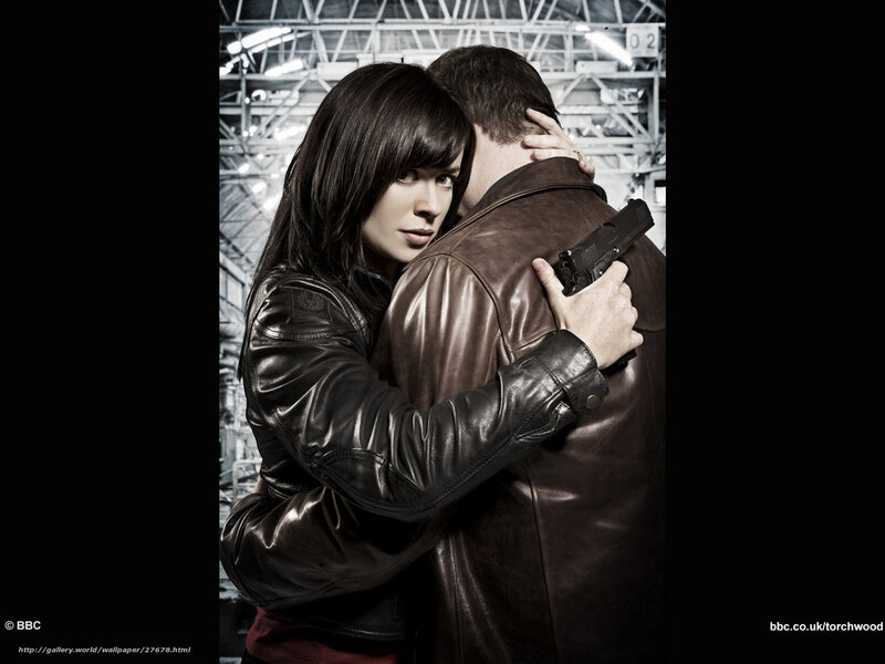 woman holding gun to man's back