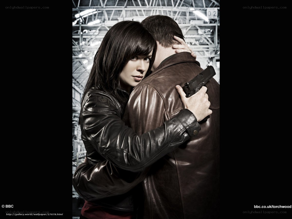 woman holding gun to man's back