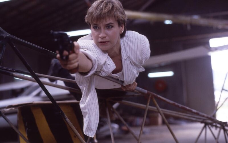 Woman Holding Gun — White, Tense