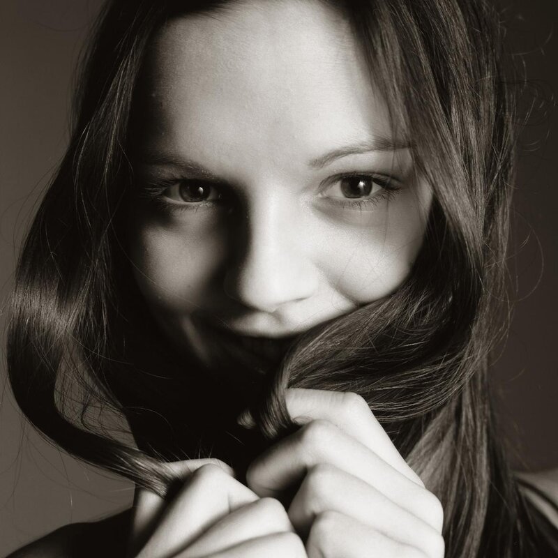 woman holding hair in front of face