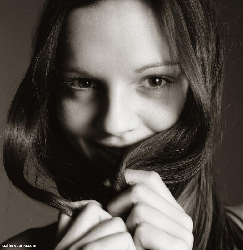 woman holding hair in front of face