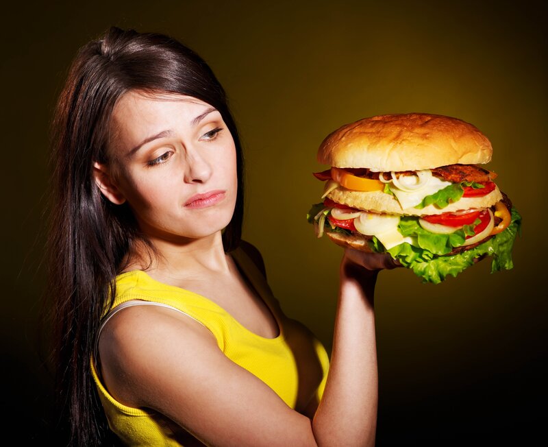 Woman Holding Hamburger — Yellow