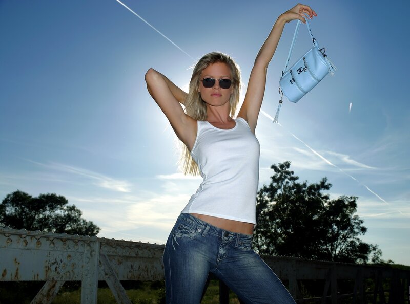 woman holding handbag on bridge