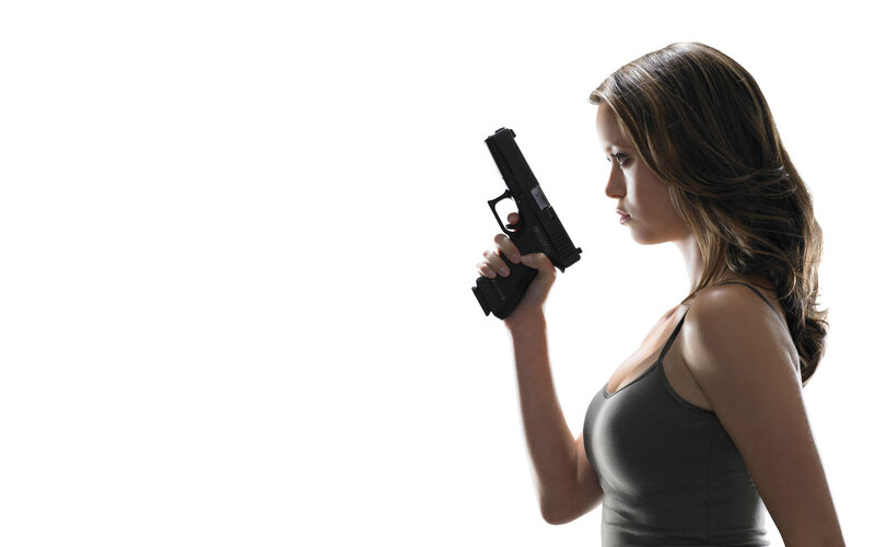 woman holding handgun in profile