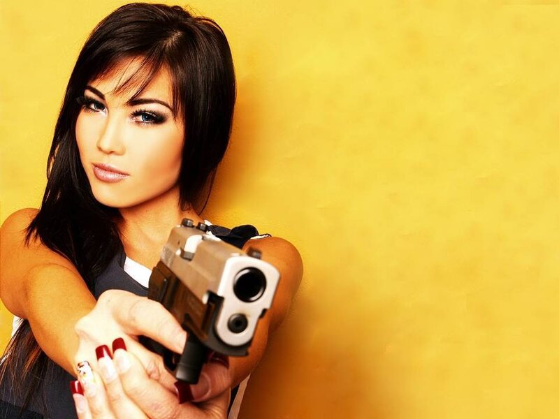 Woman Holding Handgun — Yellow