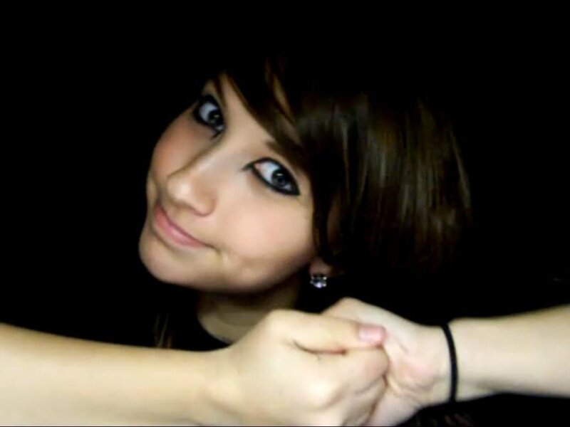 woman holding hands in dark
