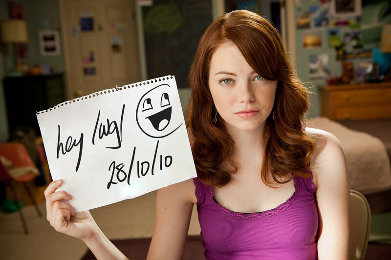 Woman holding handwritten sign