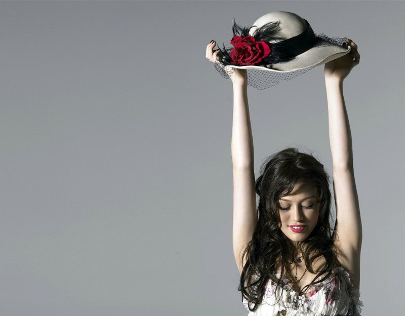 woman holding hat above head