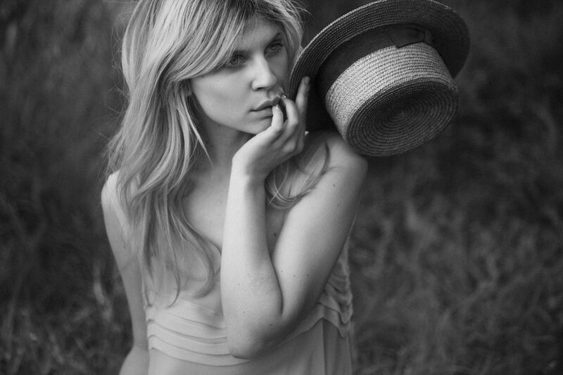 Woman Holding Hat — Black