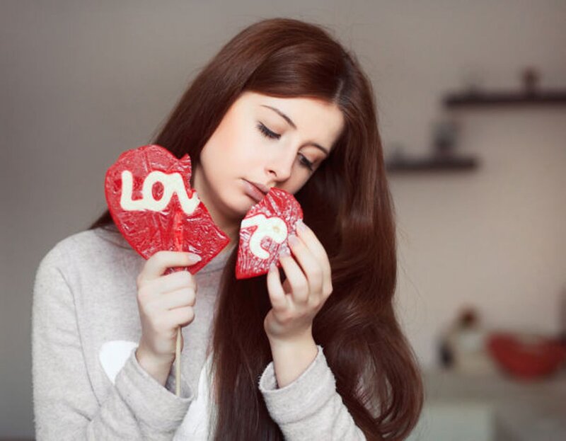 Woman Holding Heart Lollipops