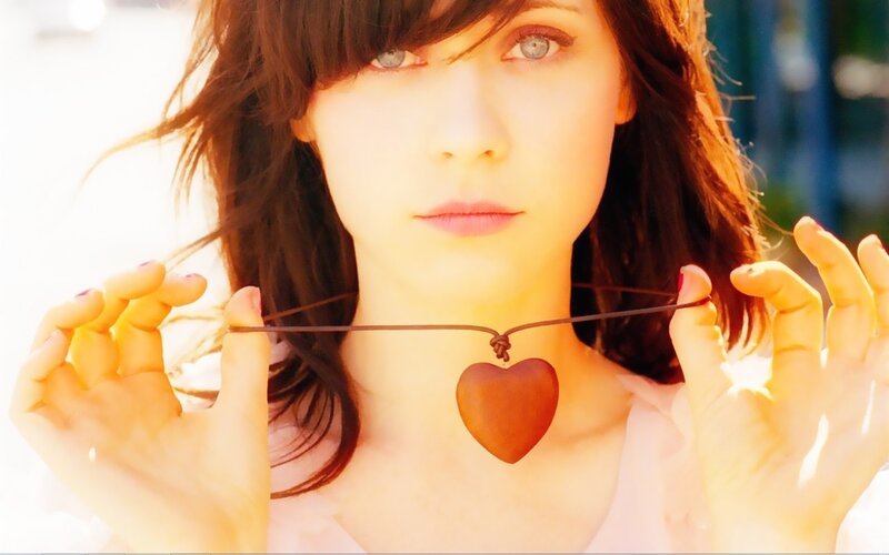 woman holding heart necklace