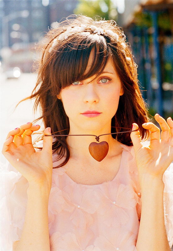 woman holding heart necklace