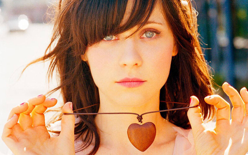 woman holding heart pendant
