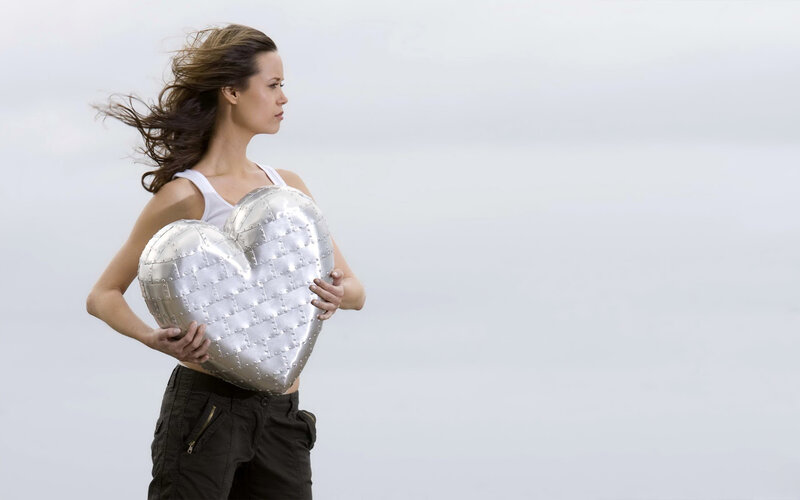 Woman Holding Heart Pillow — Silver, Calm