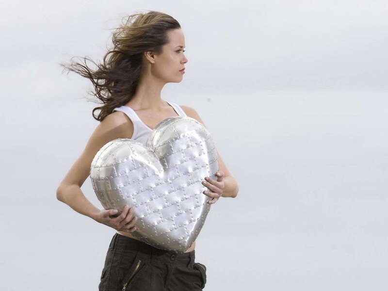 Woman Holding Heart Pillow — Silver