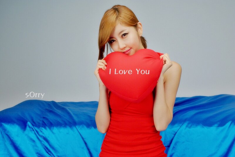 Woman holding heart pillow