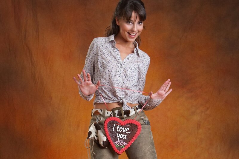 Woman holding heart-shaped cookie