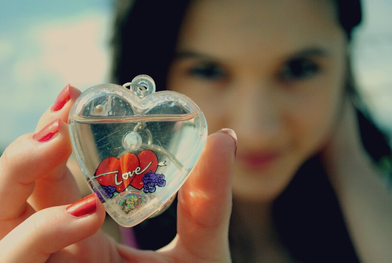 woman holding heart-shaped locket