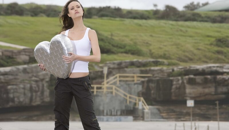 Woman holding heart-shaped object