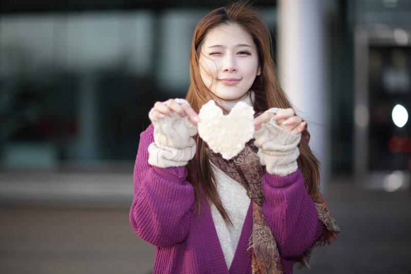 woman holding heart-shaped object