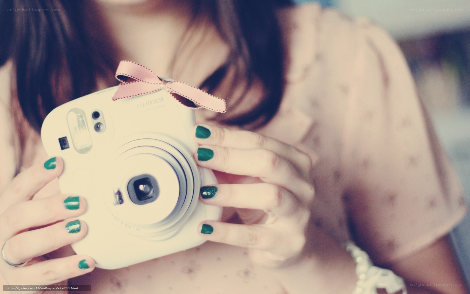 woman holding instant camera