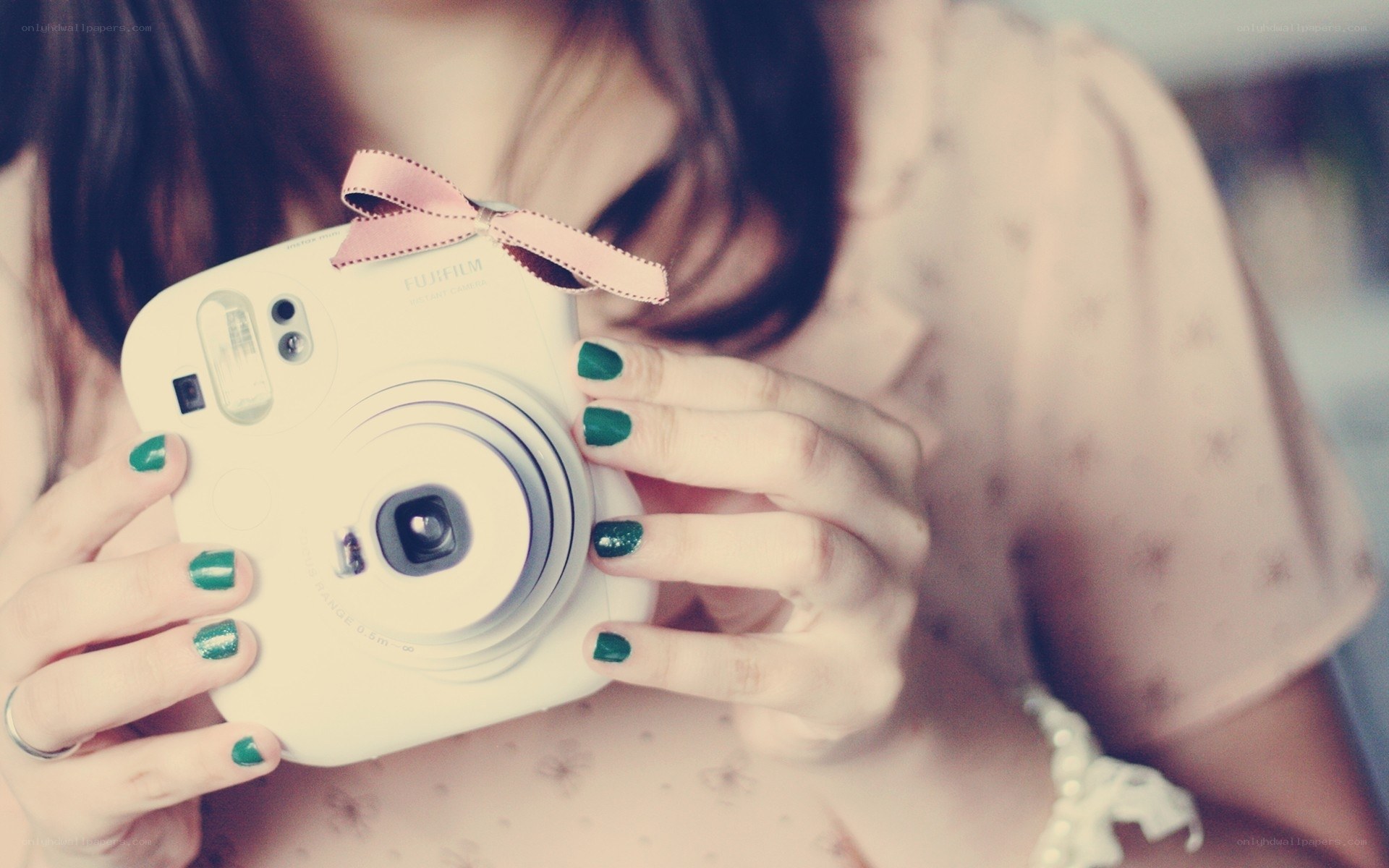 woman holding instant camera