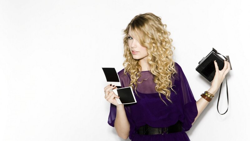 woman holding instant photos