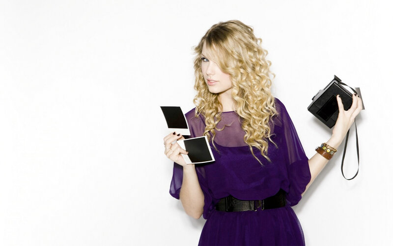 woman holding instant photos